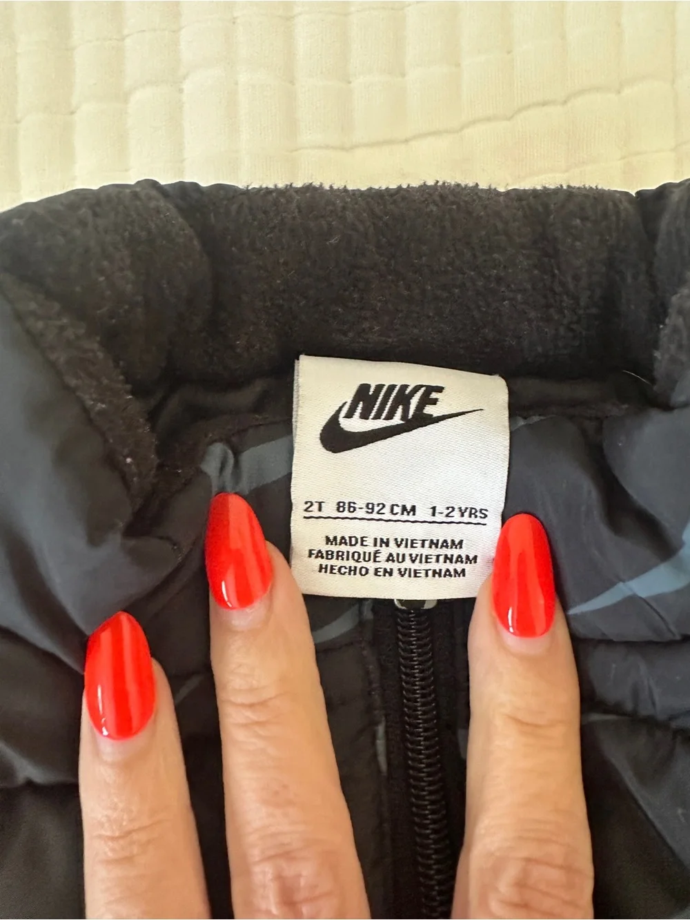 Nike Black Puffer Vest with Light Blue Swoosh and Black Leggings